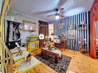 Sala de estar com piso de madeira e decoração rústica em um imóvel no Brasil.