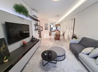 Sala de estar moderna com sofá e televisão.