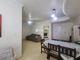 Interior de uma sala com sofá e cama em um imóvel no Brasil.