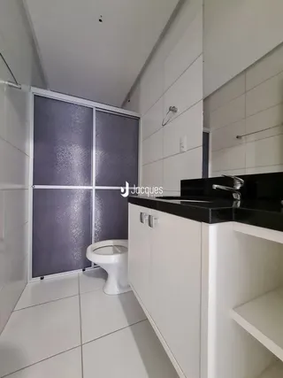 Foto de um banheiro interno com vaso sanitário e piso branco.