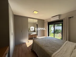 Este é um quarto com cama grande e armários embutidos em um ambiente bem iluminado.