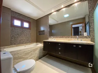 Foto de um banheiro com banheira e louças sanitárias em um imóvel.