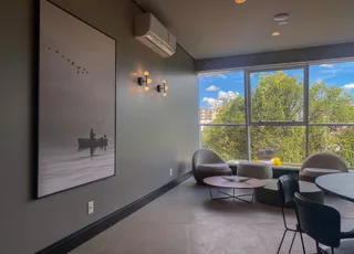 Sala de estar com grandes janelas e decoração moderna.