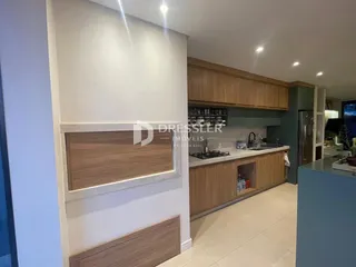 Foto de uma cozinha moderna com armários de madeira e bancadas claras.