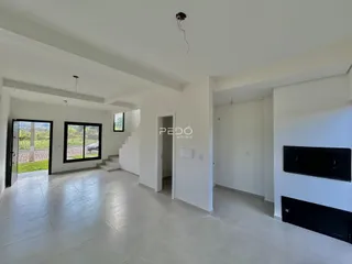 Vista interna de um ambiente com piso claro e paredes brancas.