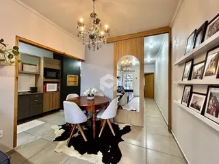 Ambiente interno de sala de jantar e cozinha com piso de cerâmica e detalhes em madeira.