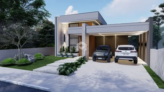 Fachada moderna de uma residência em Lajeado, Brasil, com paisagismo e garagem.