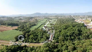 Vista aérea de uma propriedade rural com áreas verdes e campos.