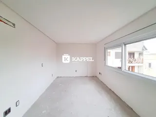 Foto de um cômodo vazio com paredes brancas e piso de concreto.