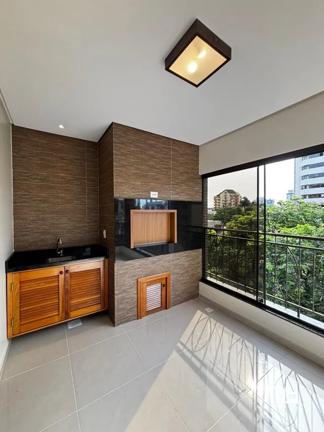 Sala com parede de destaque e vista para o exterior.