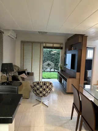 Sala de estar com vista para o jardim através de portas de vidro.