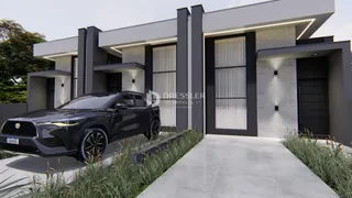 A fachada de uma casa moderna em Lajeado, Brasil com uma garagem e jardim frontal.