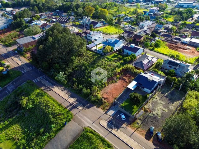 Vista aérea de uma área residencial em Lajeado, Brasil, mostrando casas e vegetação.