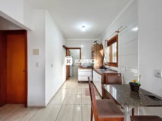 Hall de entrada com piso claro e paredes brancas em um imóvel.