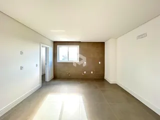 Vista interna de um ambiente com paredes brancas e piso de cerâmica.