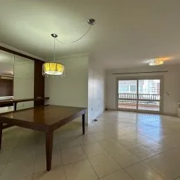 Sala de estar com piso de cerâmica e mesa de madeira.