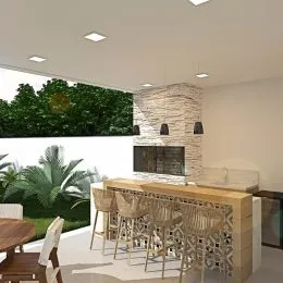 Foto de uma área de cozinha com balcão de madeira e banquetas.