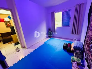 Sala de estar com paredes roxas e piso azul.