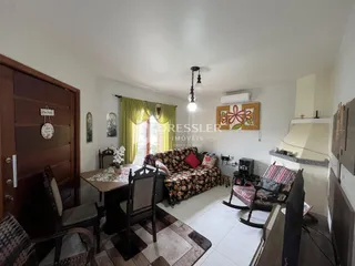 Sala de estar com móveis e portas de madeira em um imóvel no Brasil.