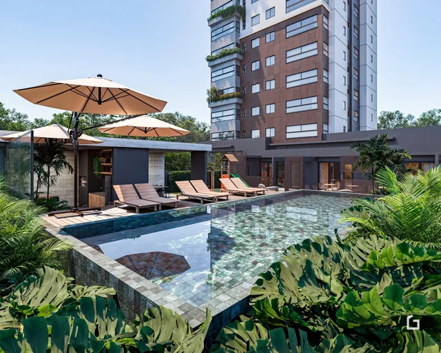 Vista externa de uma piscina e área de lazer em um complexo residencial.