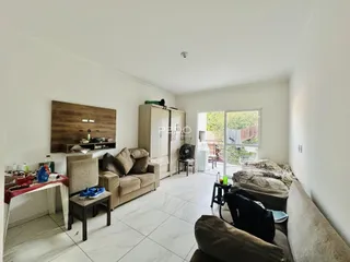 Sala de estar com piso de cerâmica e sofá em um imóvel em Lajeado.