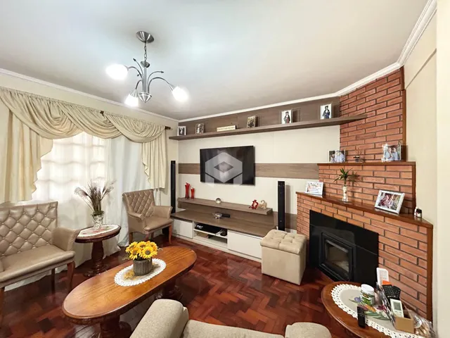 Sala de estar com piso de madeira e lareira em um imóvel no Brasil.