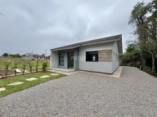 Fachada de uma casa moderna em Lajeado, Brasil, com área de estacionamento de cascalho.
