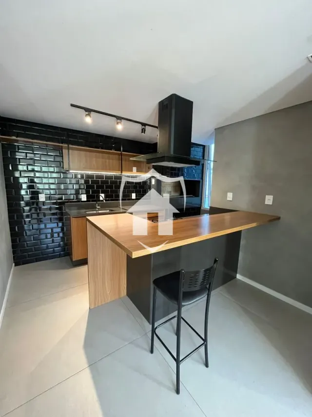 Cozinha moderna com armários de madeira e backsplash preto.