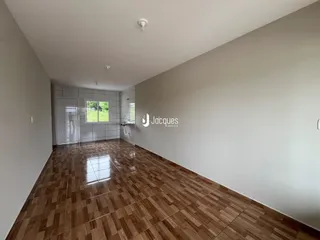 Hall de corredor com piso de madeira no imóvel.