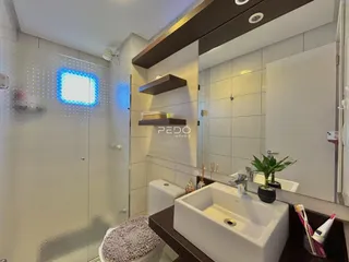 Foto de um banheiro moderno com box de vidro e bancada branca.