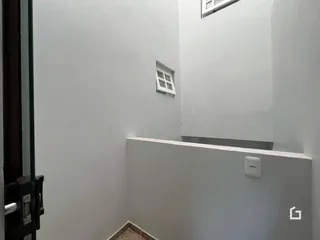 Parede interna com janela e tomada em uma residência.