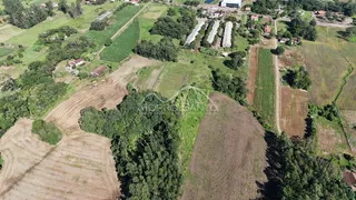 Vista aérea de uma área rural com campos cultivados e vegetação densa em Lajeado.