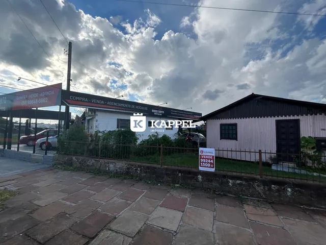 Fachada de uma residência em Lajeado, Brasil, com sinalização de venda visível.