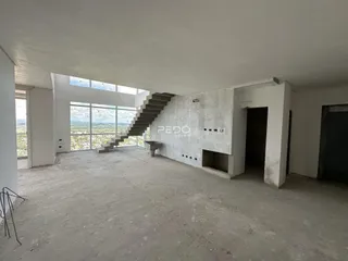 Espaço interno amplo com vista panorâmica de paisagem.