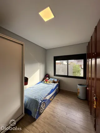Quarto com cama e armário de madeira no imóvel.