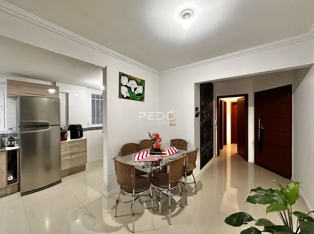 Sala de jantar com mesa de vime e cadeiras em um imóvel no Brasil.