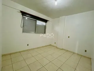 Foto de uma sala com piso de cerâmica clara e janela.
