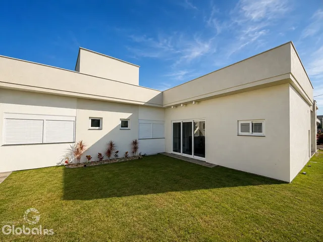 Fachada externa de uma residência moderna com jardim gramado em Lajeado, Brasil.