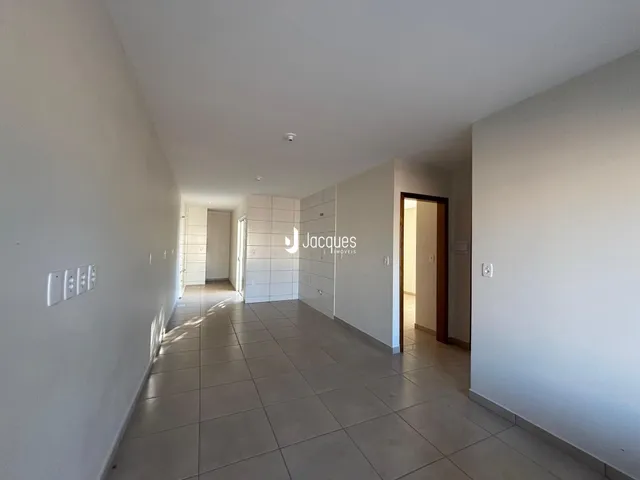 Corredor interno de uma residência com piso de cerâmica.