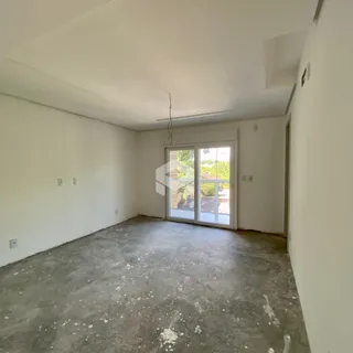 Ambiente interno de uma sala com piso de concreto.