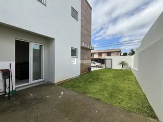 Vista da fachada de uma residência em Lajeado, Brasil, com um jardim gramado.