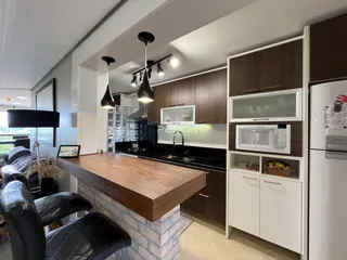 Imagem de uma cozinha e sala de estar em um imóvel no Brasil.