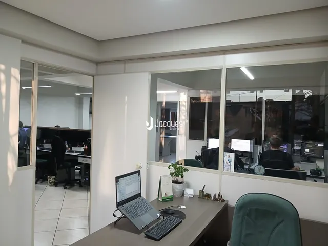 Vista de um escritório com divisórias de vidro.