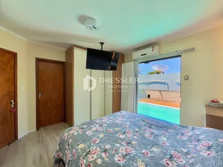 Quarto com cama e portas de madeira em um imóvel.