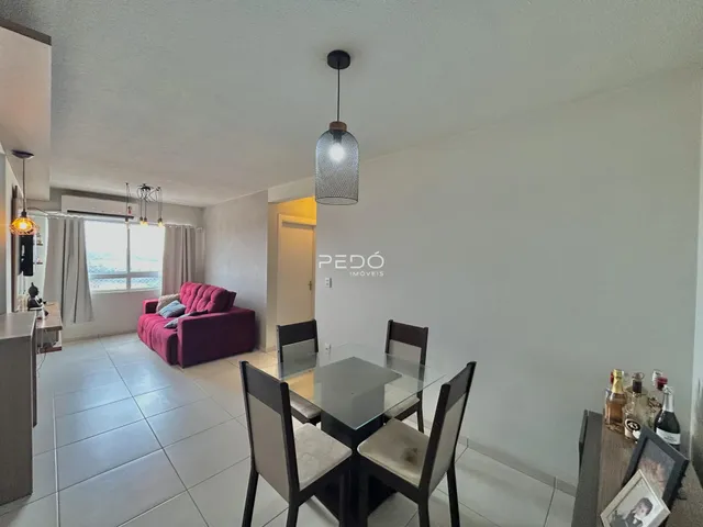 Sala de jantar com mesa de vidro e ambiente claro.