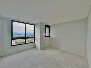 Ambiente interno com grande janela de vista para a paisagem.