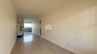 Corredor interno de uma residência com piso de cerâmica clara.