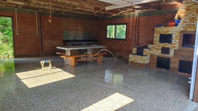 Ambiente interno com paredes de tijolo aparente e piso de concreto polido.