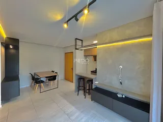 Sala de estar com cozinha integrada e mesa de jantar em um imóvel em Lajeado.
