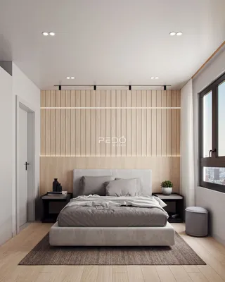 Quarto com cabeceira e parede de madeira clara.